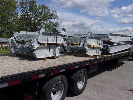 metal parts strapped down on a trailer